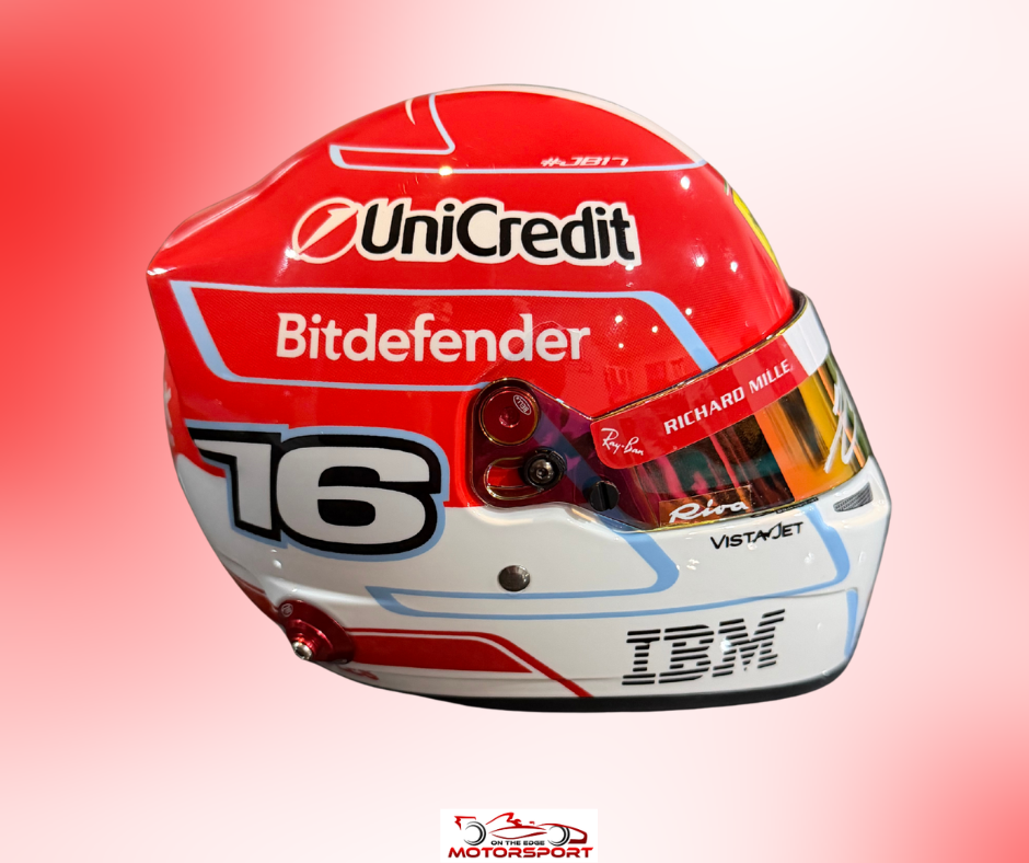A red and white racing helmet with sponsor logos including UniCredit, Bitdefender, Richard Mille, Vistajet, and IBM, shown against a red-to-white gradient background.